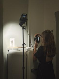 my assistant, taking photos of the artworks, studio set up in a hotel room, aesthetic photos
